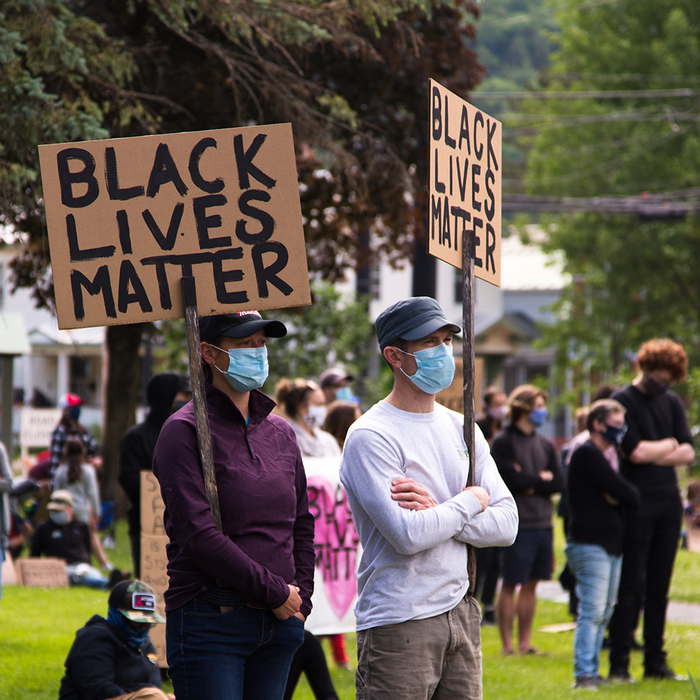 2 Waterbury residents wearing face masks and holding 'BLACK LIVES MATTER' signs